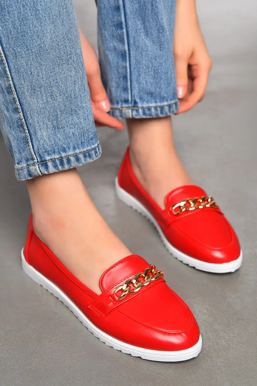 Red leather loafers with gold chain and white sole
